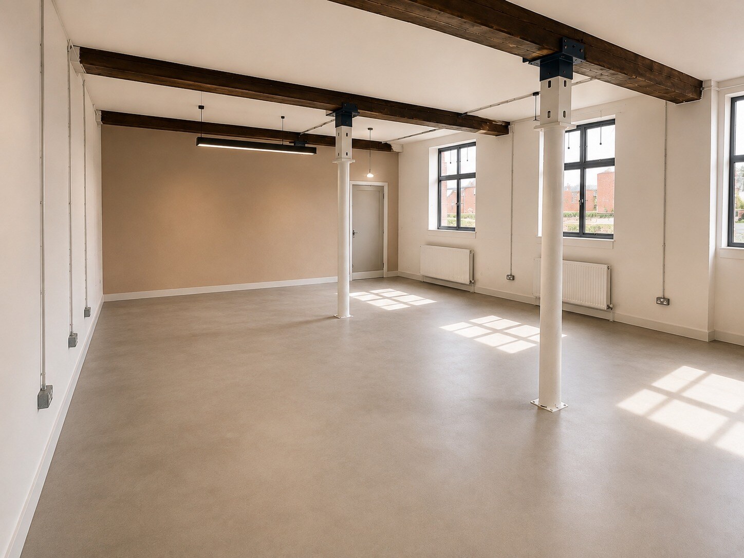 Bright open unit with exposed timber beams and iron columns