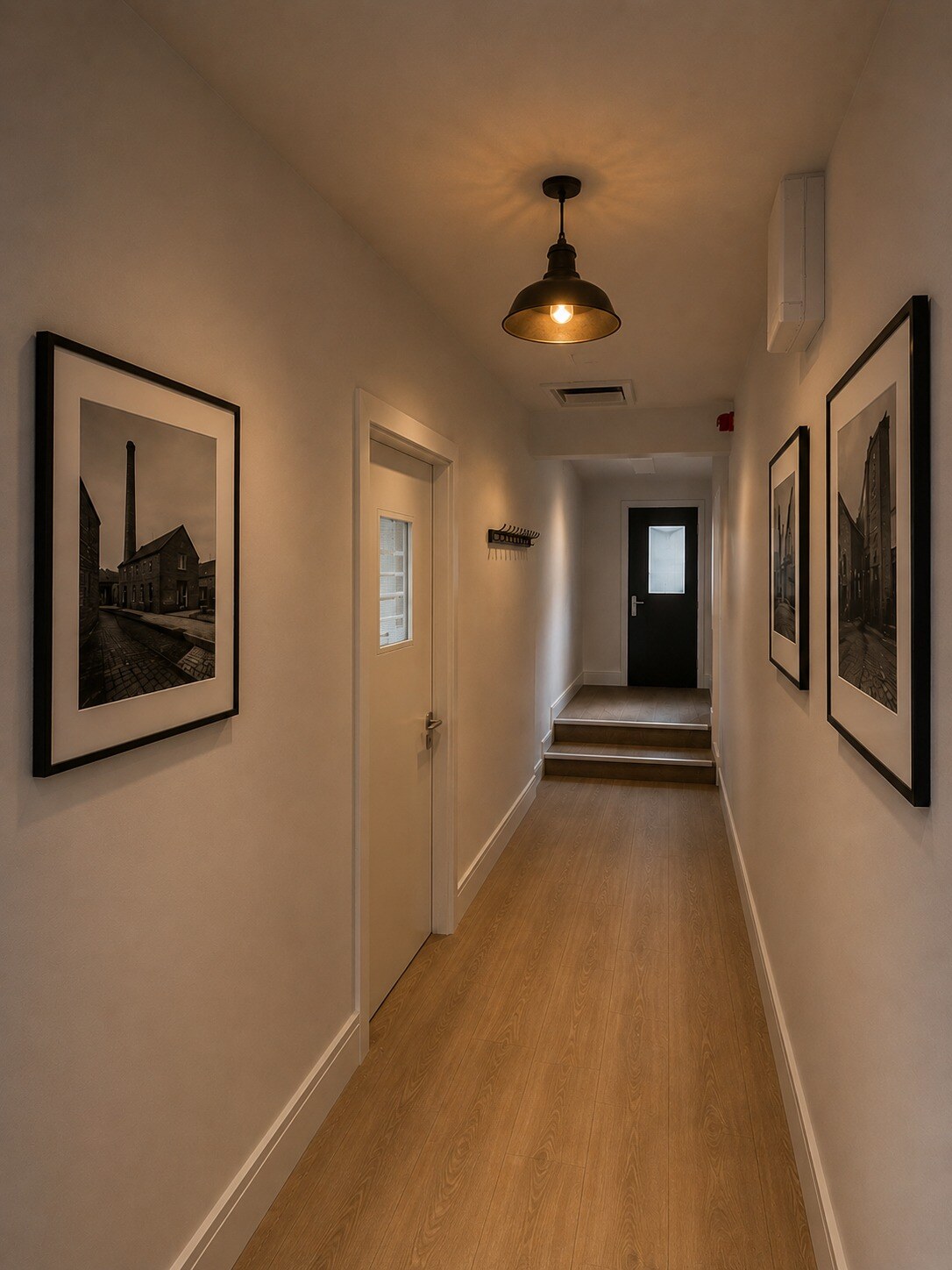 Finished corridor displaying historic Westgate Brewery photographs