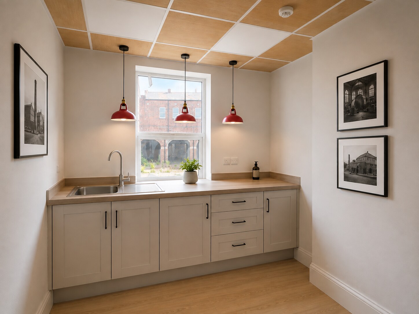 Shared kitchen with heritage photographs and red pendant lights